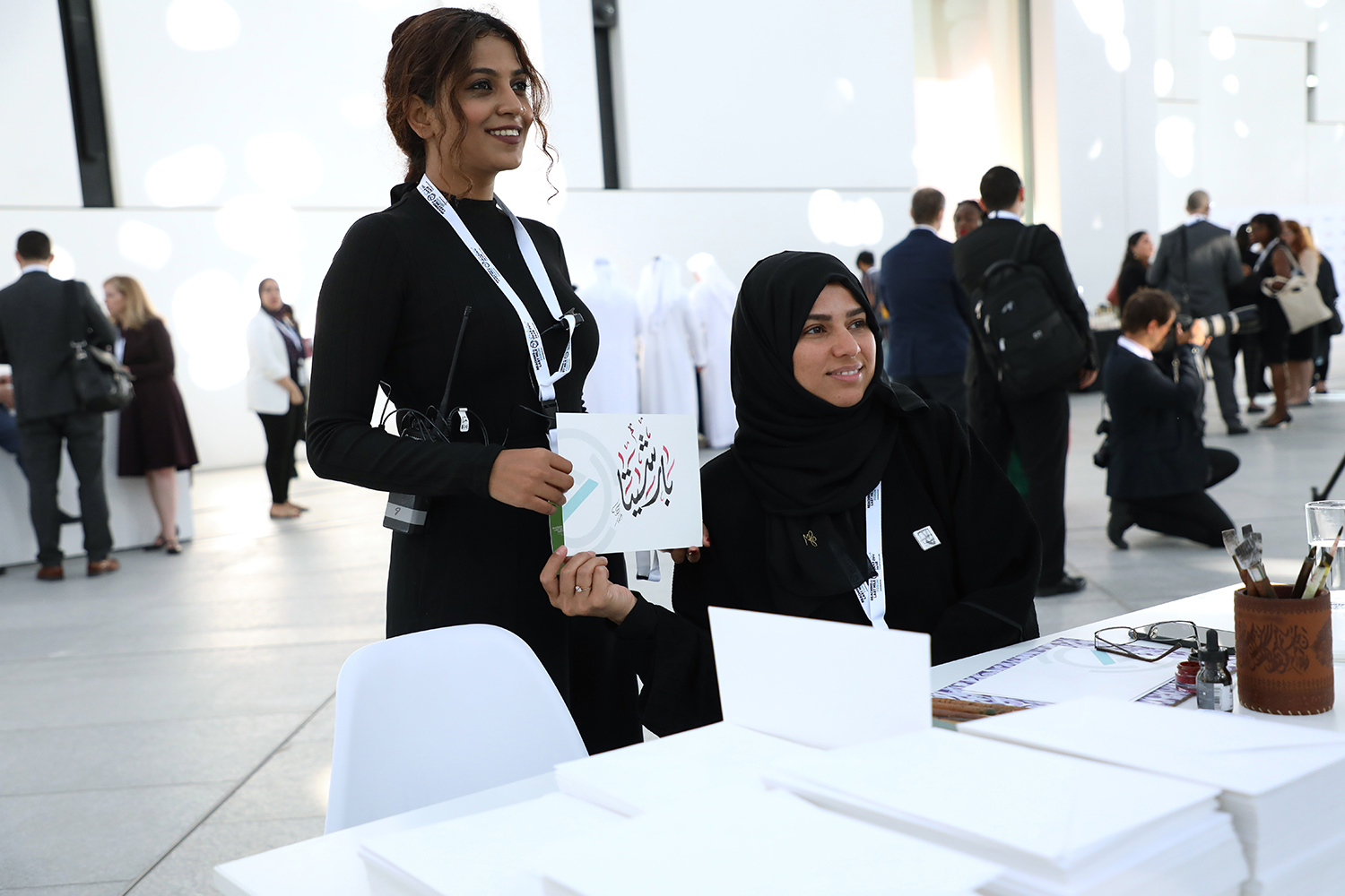 Registration counters fabricated to match the forum’s white scenic environment.