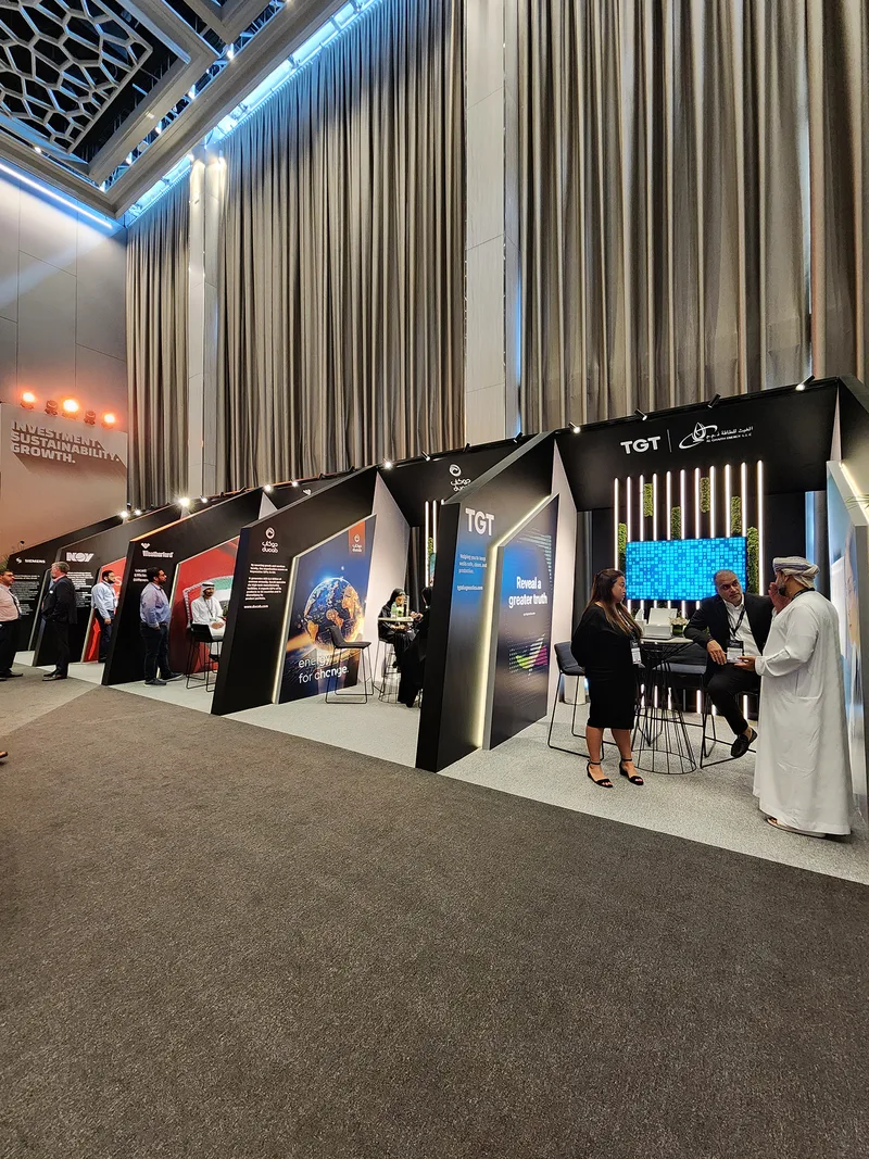 MDF and plywood exhibition walls forming a cohesive branded environment for industrial sponsors.
