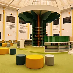 Tree-form library shelving with a broad sculpted canopy and integrated book storage.