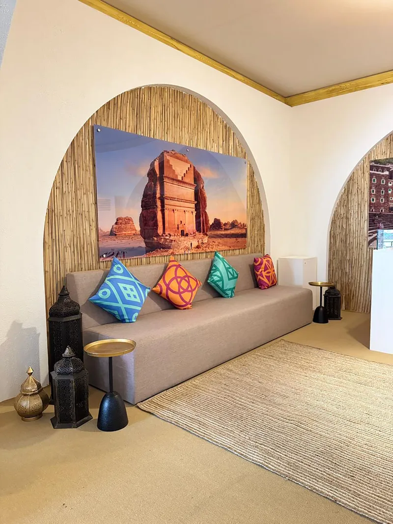 Wall-mounted acrylic branding panels installed against a crafted barasti scenic backdrop.