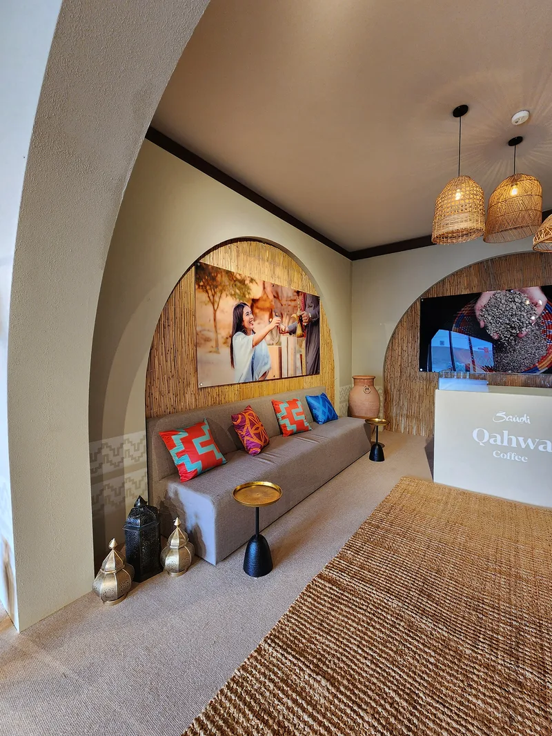 Evolution Scenic acrylic branding panel mounted on a barasti backdrop within the Visit Saudi hospitality interior.