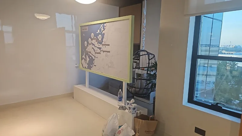 Interactive Abu Dhabi map display combining clear acrylic, paint and printed vinyl.