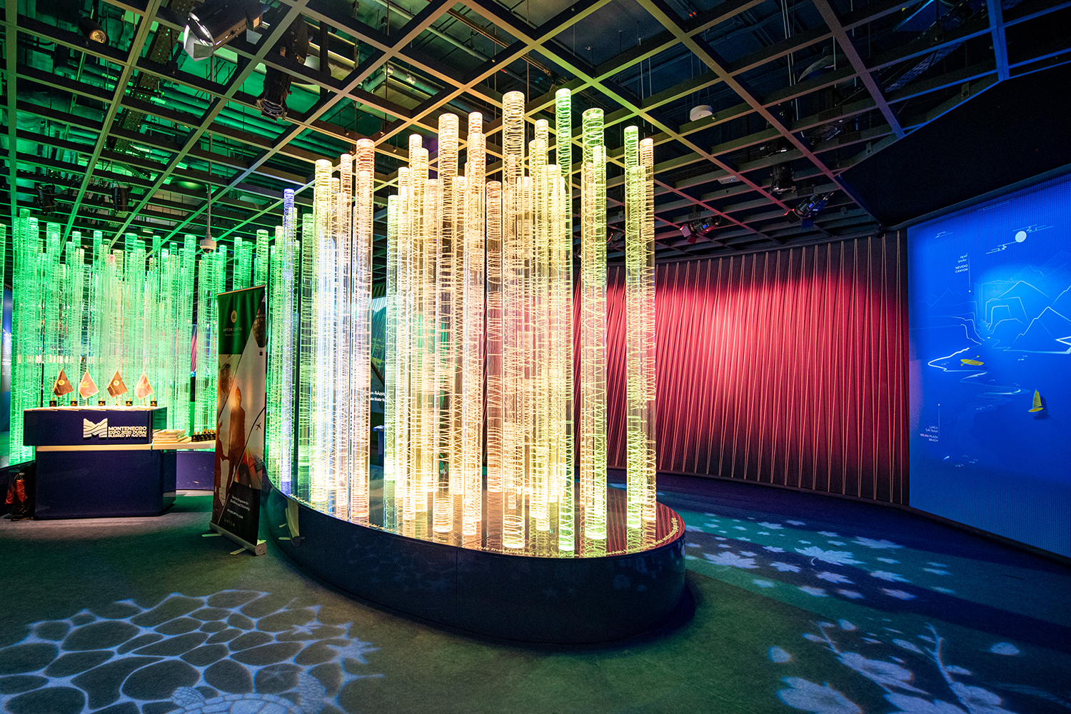 Clear acrylic fabrication creating a lightweight illuminated scenic feature inside the pavilion.