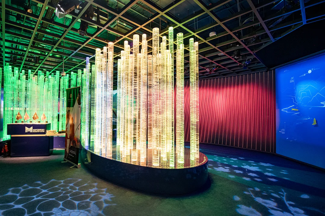 Clear acrylic fabrication creating a lightweight illuminated scenic feature inside the pavilion.