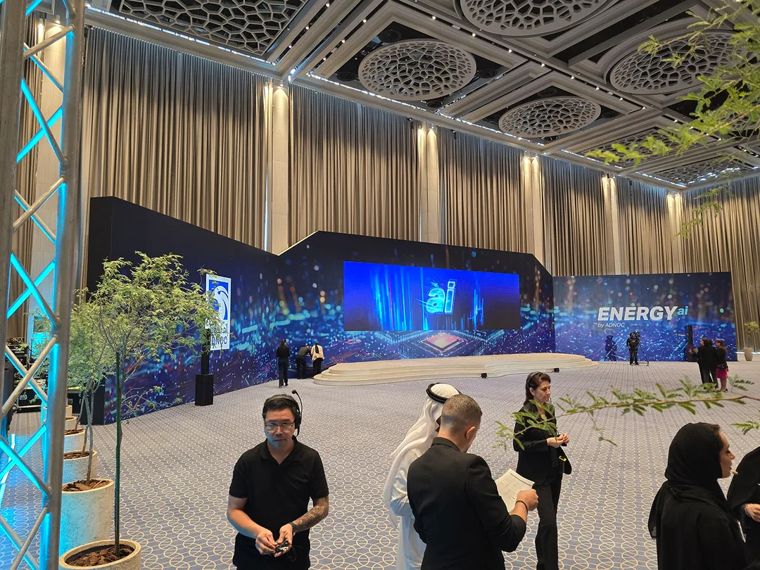 Branded scenic fabrication demonstrating integrated stage, graphics and technical equipment concealment.