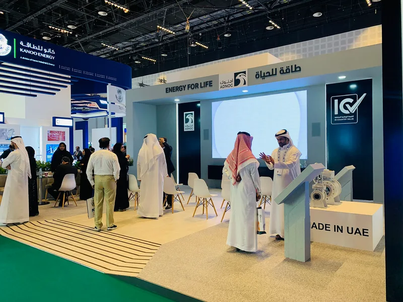 Custom scenic display structures and integrated digital screens within the ADNOC ADIPEC 2022 stand