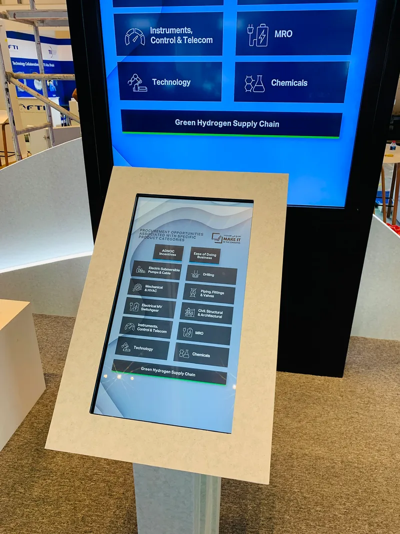 Custom scenic display structures and integrated digital screens within the ADNOC ADIPEC 2022 stan