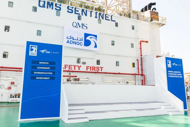 White-painted plywood steps and carpeted scenic stage deck for the ADNOC ZMI acquisition.