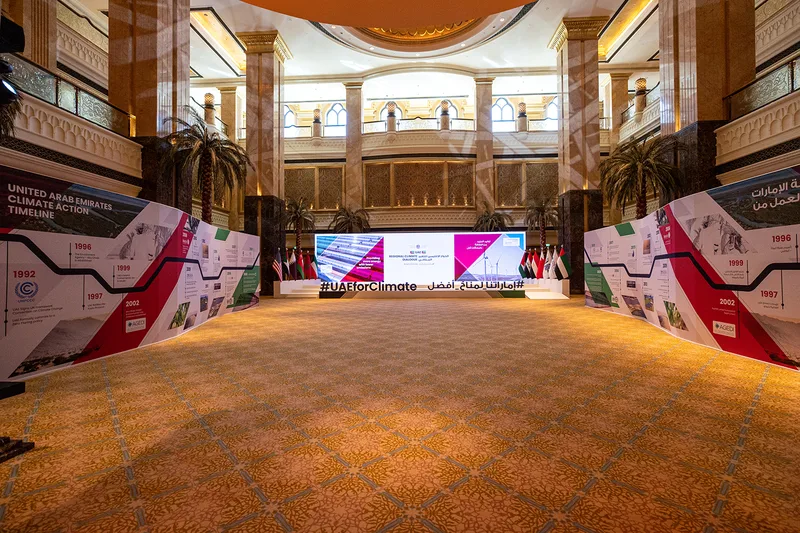 Evolution Scenic angled graphic walls framing the UAE Regional Climate Dialogue stage at Emirates Palace.