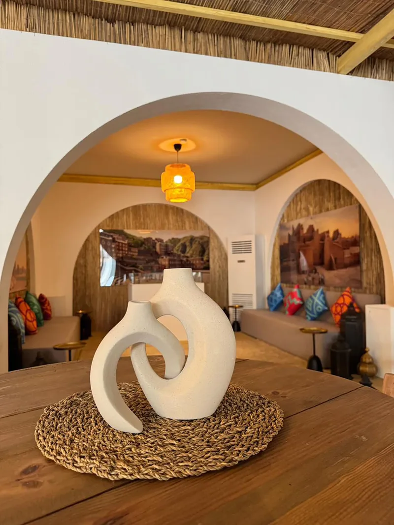Evolution Scenic arched lounge interior with barasti finishes, timber furniture and custom lighting.