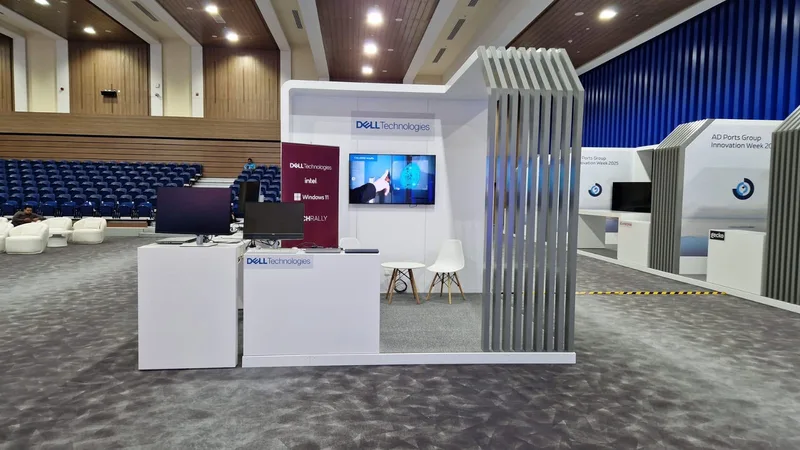 Evolution Scenic back-to-back booths with branded totems and freestanding display tables.