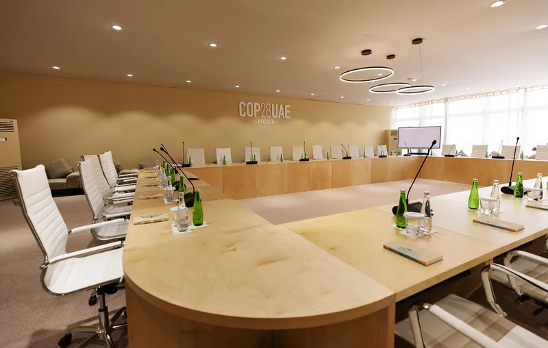 Custom birch plywood meeting table with a natural wood-effect finish.