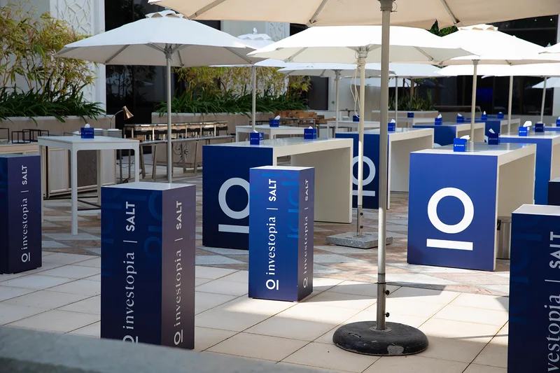 Custom branded scenic partitions organising outdoor networking and meeting areas at the Abu Dhabi Hilton.