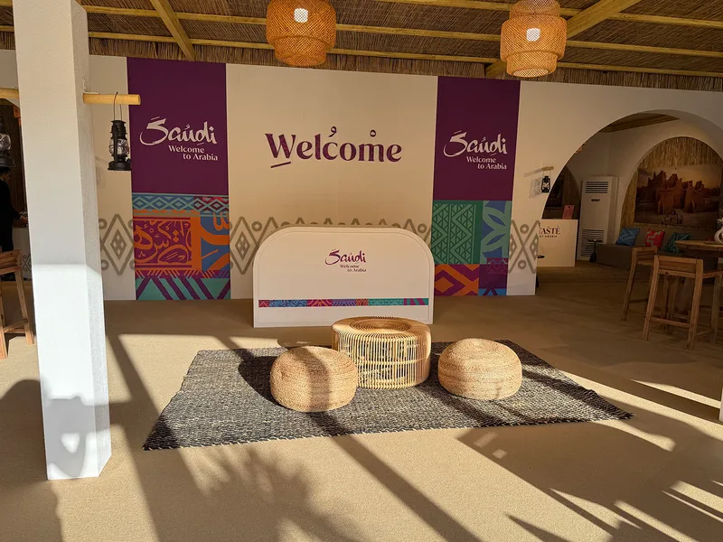 Evolution Scenic reception counter positioned within the textured hospitality tent fit-out.