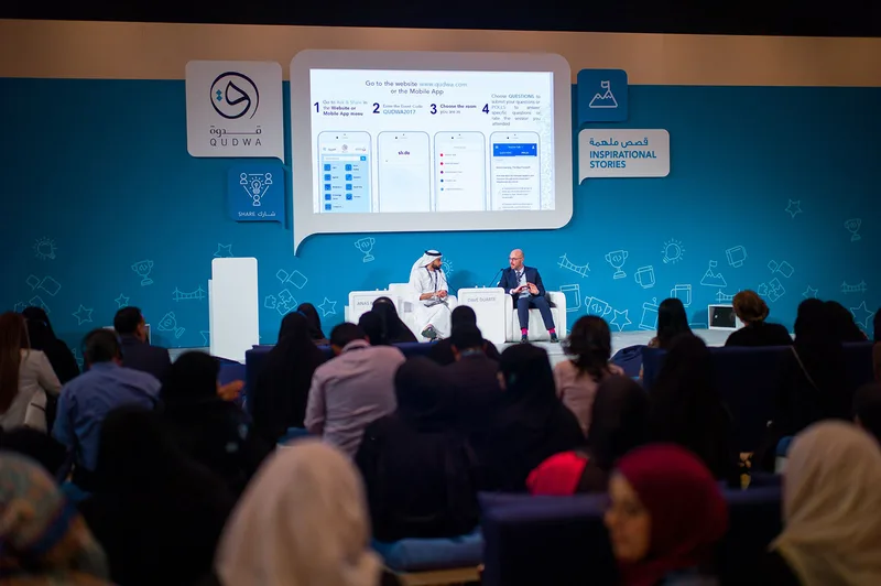 Main stage panel-session structure with dimensional branding and graphic display surrounds.