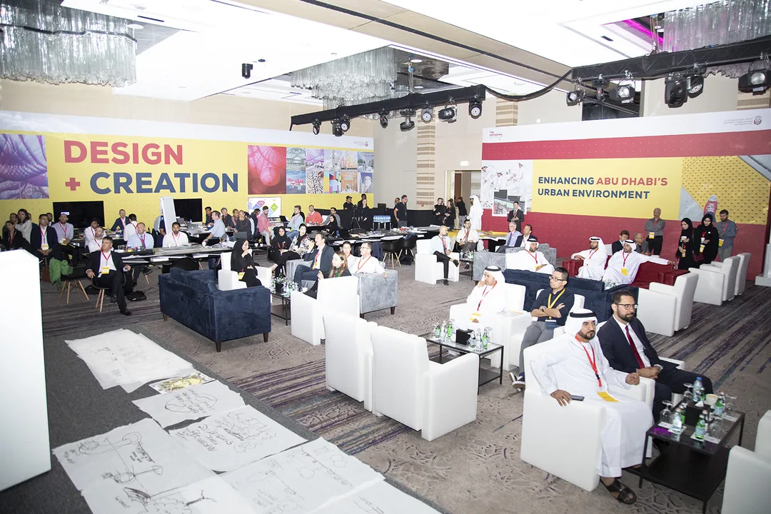 Freestanding graphic walls creating separate workshop and presentation zones.