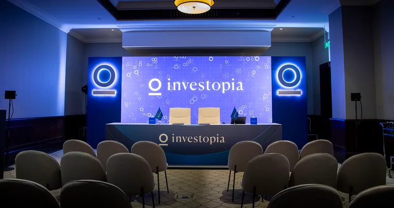 Breakout stage with illuminated branding, scenic backdrop wall and coordinated presentation platform.