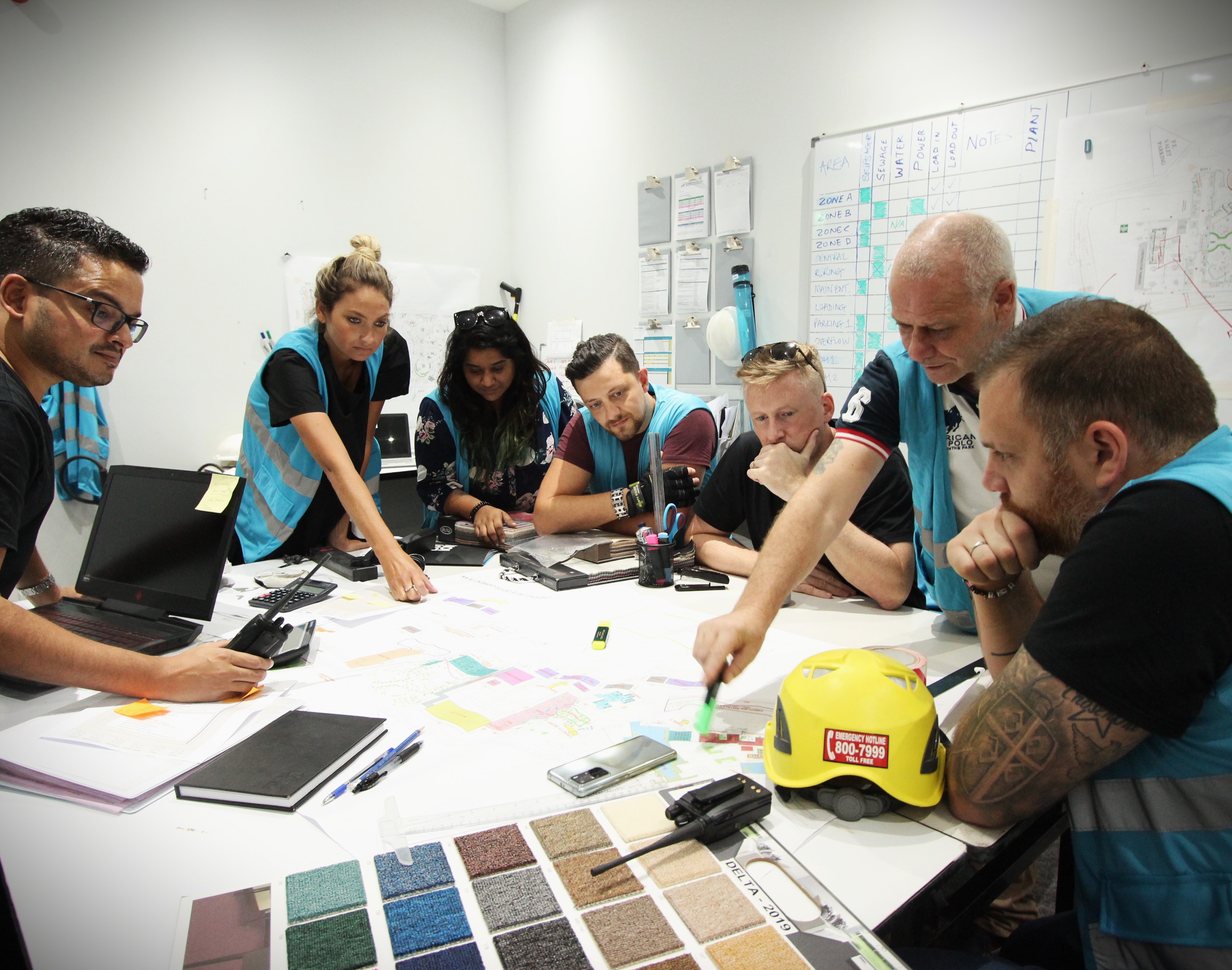 Evolution Scenic technical team reviewing scenic drawings, materials and fabrication options in the workshop.
