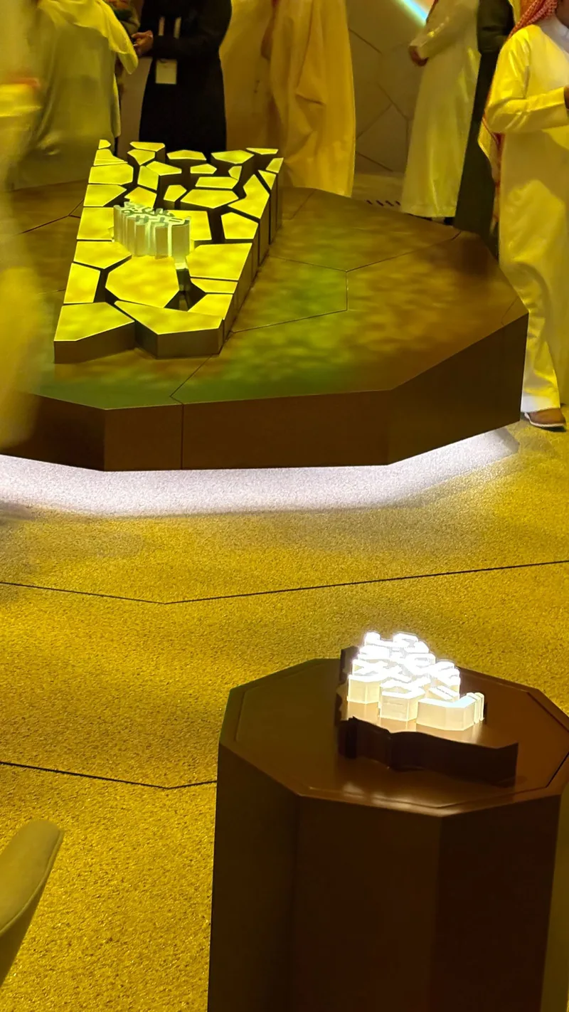 Bronze and gold metallic scenic finishes applied across the pavilion feature.