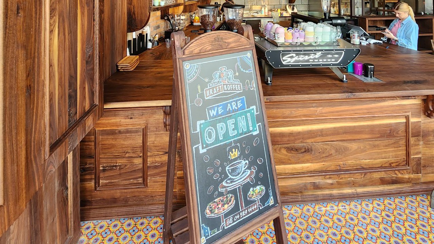 Walnut flooring installed around the bespoke coffee shop counter and fitted joinery.