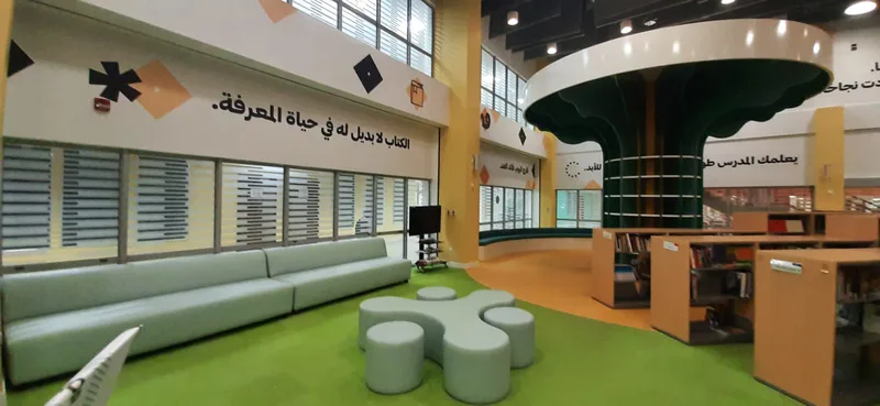Circular cushioned seating fabricated around the NCE school library tree feature.