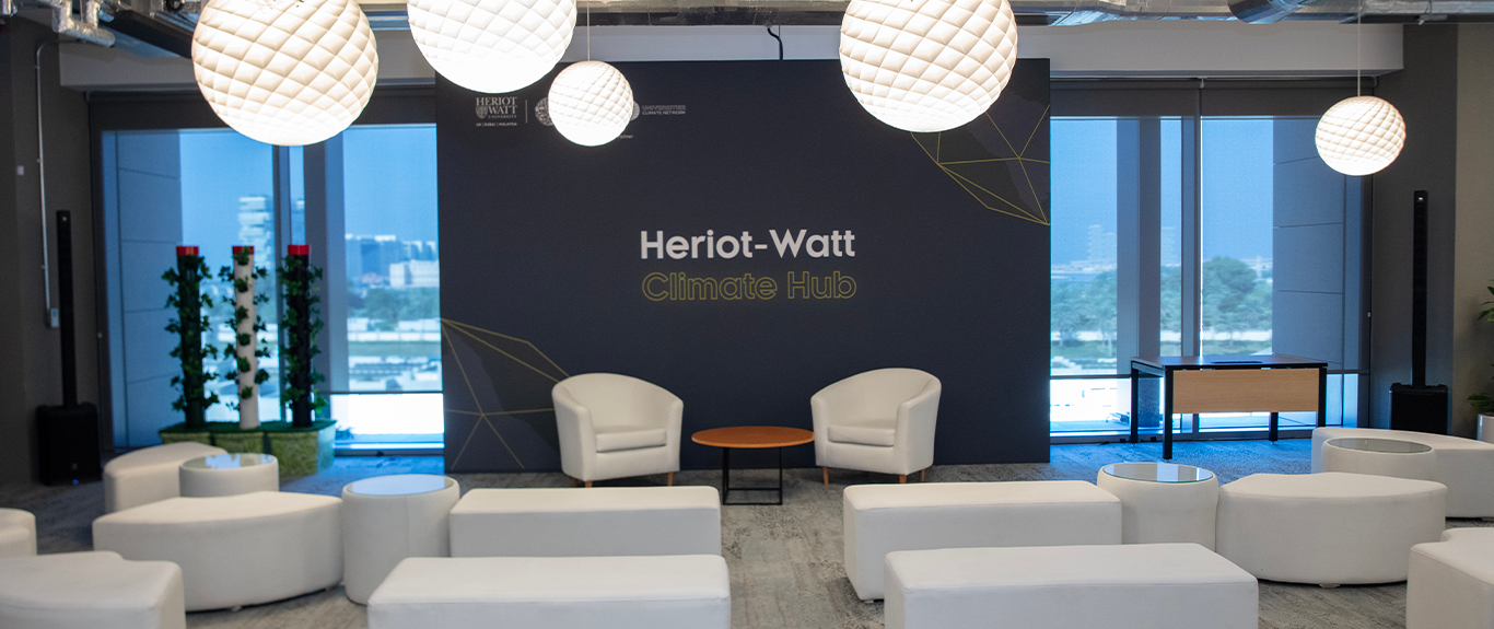 Evolution Scenic carpeted stage and printed fabric backdrop for the Heriot-Watt Climate Hub in Dubai.
