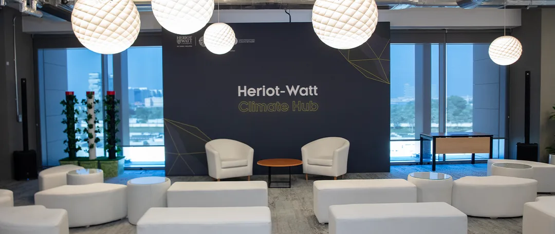 Evolution Scenic carpeted stage and printed fabric backdrop for the Heriot-Watt Climate Hub in Dubai.