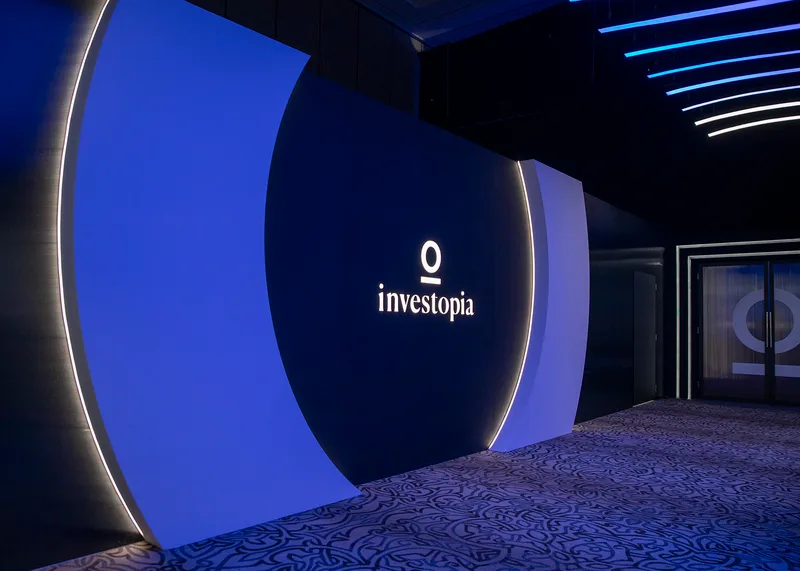 Painted entrance lobby wall with CNC-routed branding and concealed backlighting.