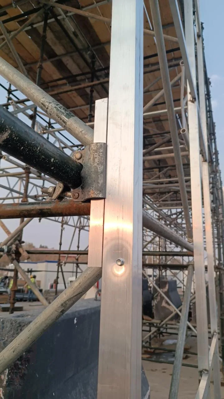 Steel primary structure supporting aluminium secondary framing for curved scenic cladding.
