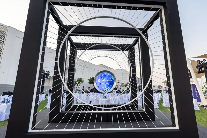 Concentric terrace feature framing the Investopia gala dinner area with illuminated circular branding.