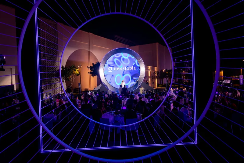Large concentric ring structure framing the branded gala dinner scenic backdrop.
