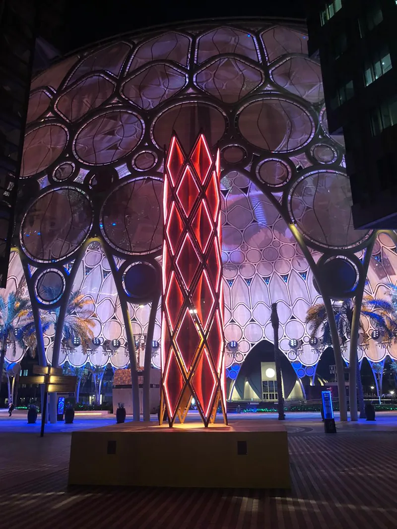 Reflective vinyl and geometric acrylic panels forming the illuminated Minaret 2.0 elevations.