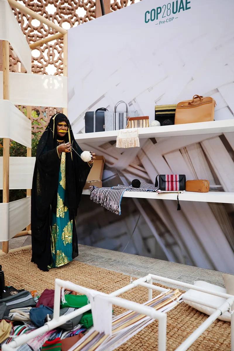 Evolution Scenic printed product-display wall with painted MDF shelving for Emirati craft presentation.