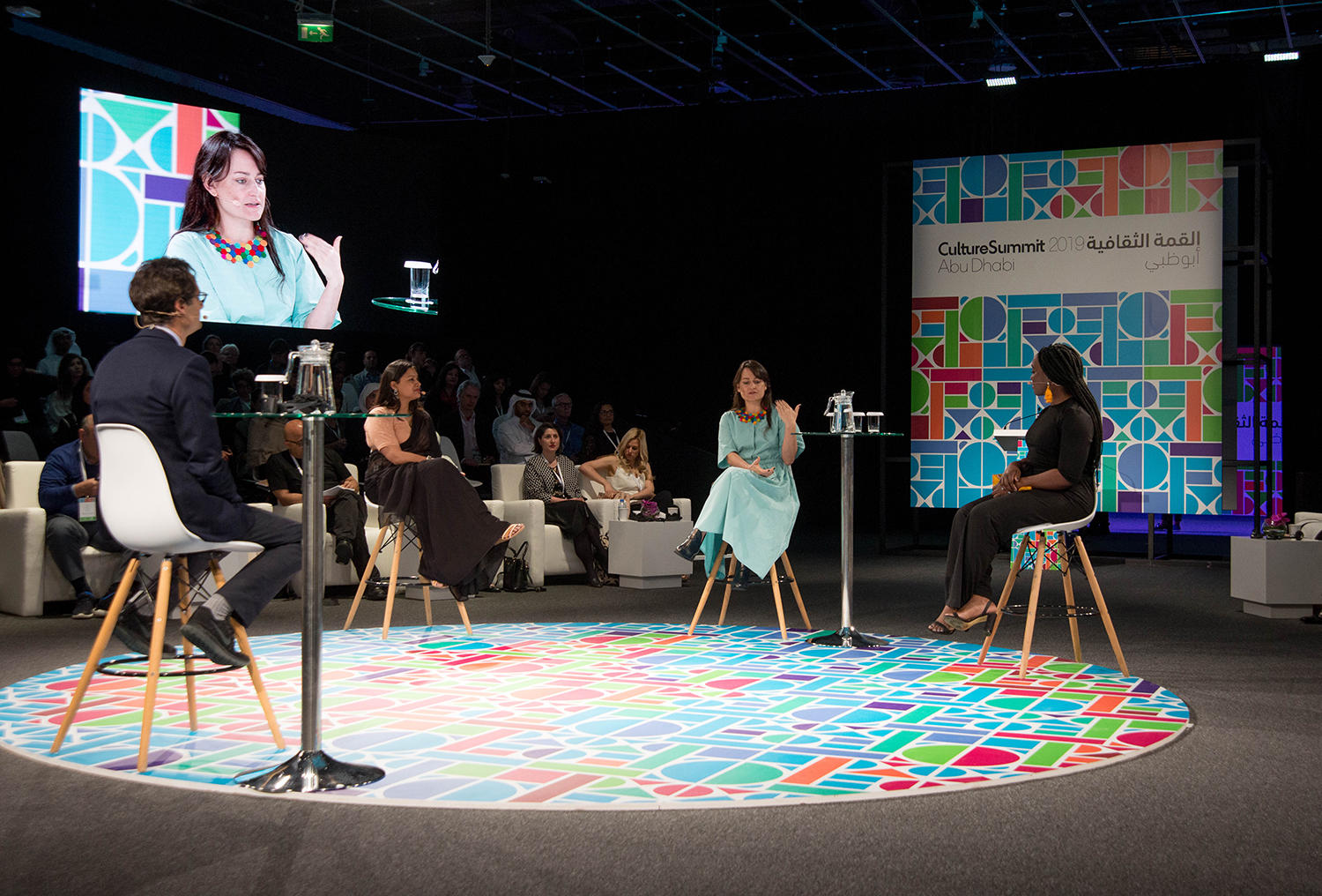 Evolution Scenic circular stage with colourful geometric floor graphics at Culture Summit Abu Dhabi.