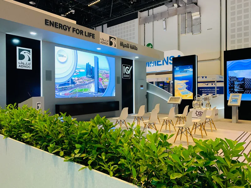 Evolution Scenic custom exhibition fabrication with white painted scenic surfaces and integrated screen apertures