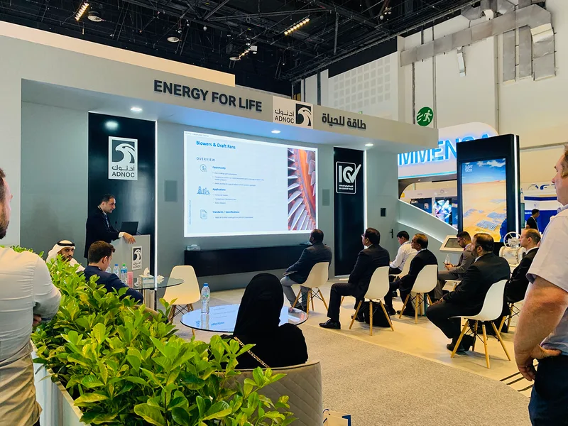 ADNOC exhibition architecture combining presentation seating, integrated screens and custom scenic construction at ADIPEC Abu Dhabi
