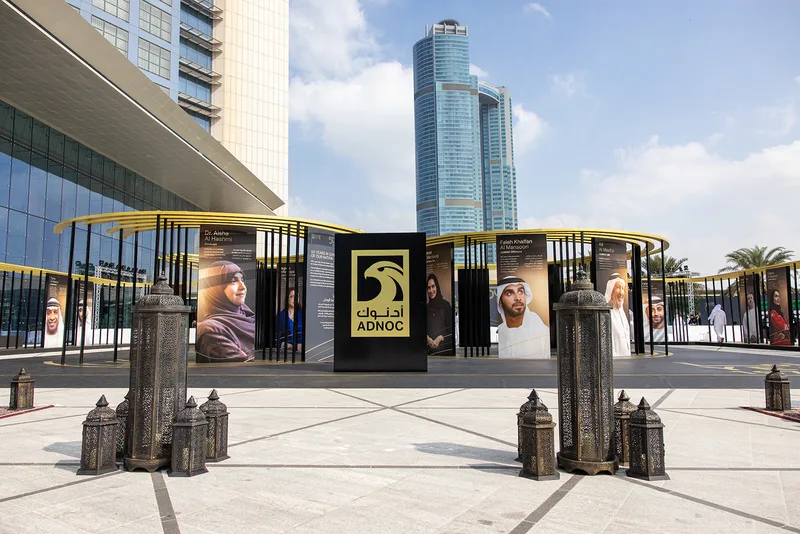 Custom scenic fabrication combining branded structures and practical finishes for ADNOC.