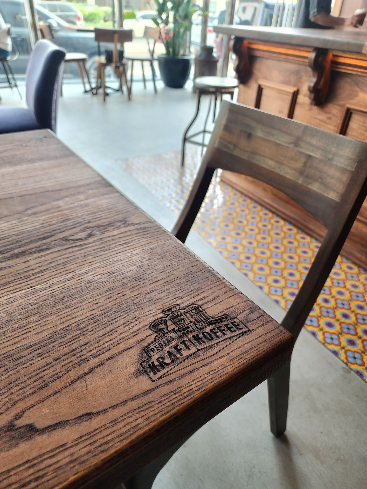 Bespoke walnut table tops fabricated by Evolution Scenic for the coffee shop interior.

