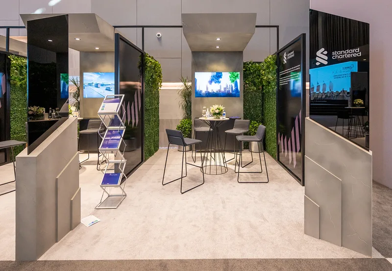 Bespoke MDF exhibition stand featuring integrated screens, lighting and custom scenic finishes