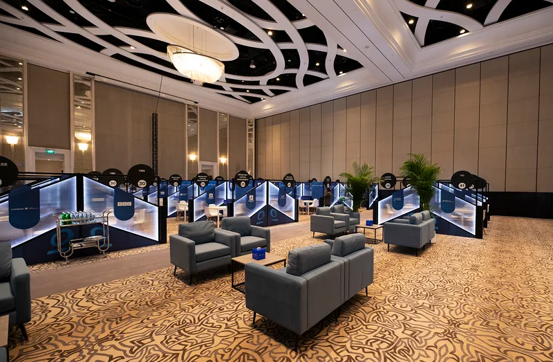 Custom Investopia networking booths with integrated storage cabinets and coordinated scenic partitions.