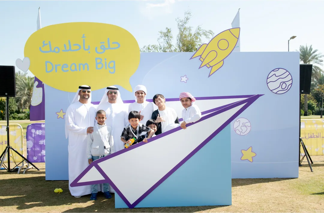 Freestanding Dream Big scenic structure with oversized paper-aeroplane photo opening.