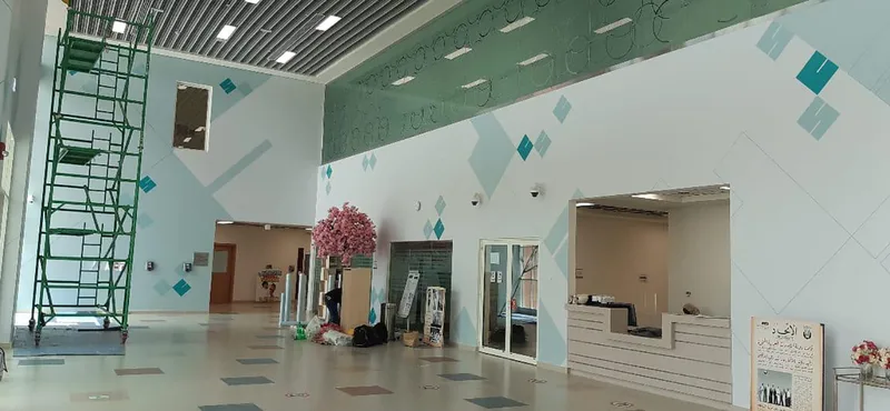 Evolution Scenic custom visitor-registration counter installed inside an NCE school entrance.