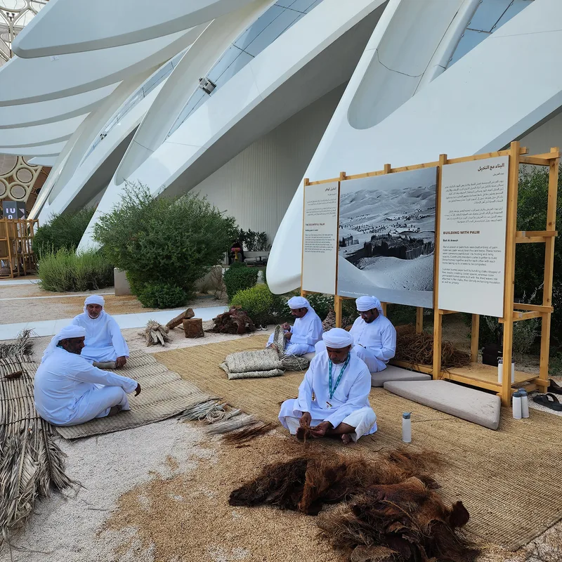 Date-palm craft display arranged within reusable timber scenic frames at Expo City.
