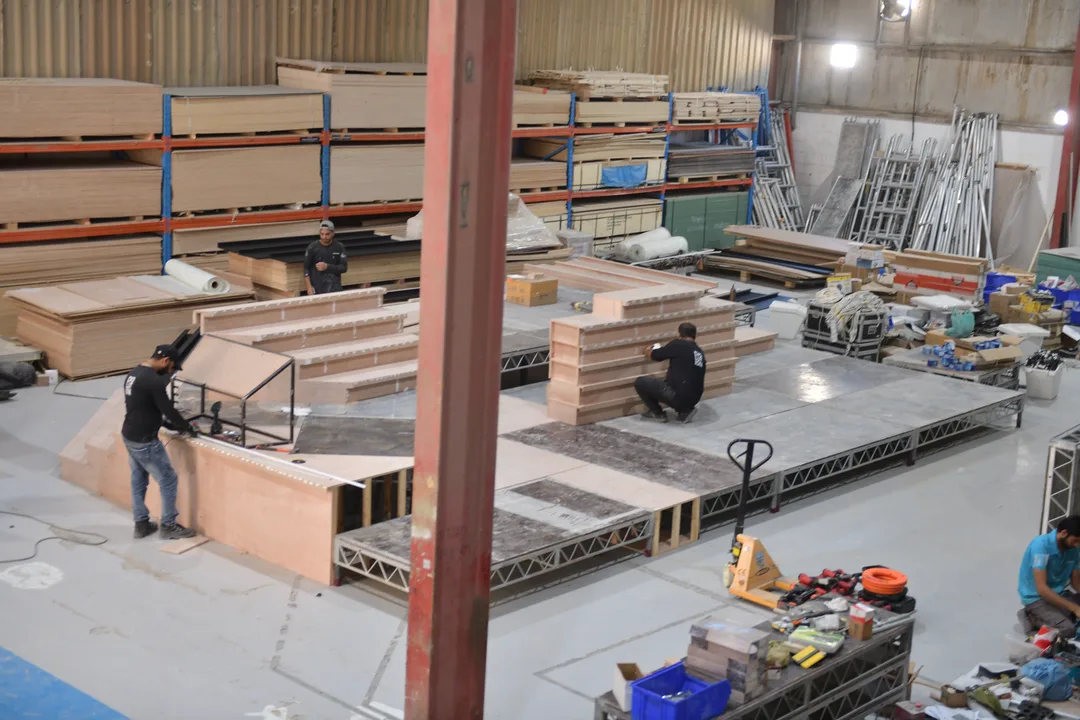 Fabrication team checking numbered scenic modules before final assembly and finishing.