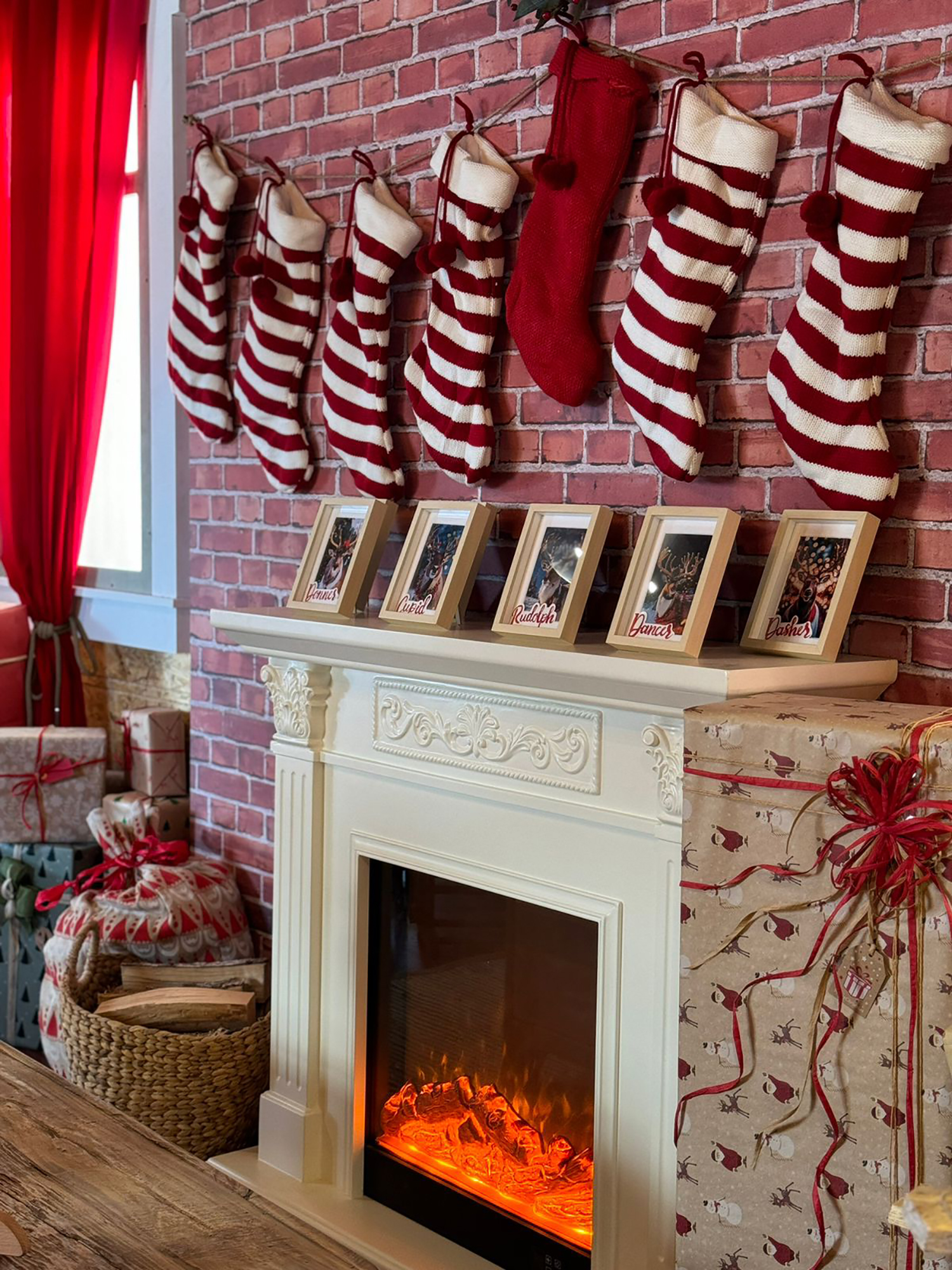 Festive interior joinery with red curtains, shelving, props and painted scenic finishes.