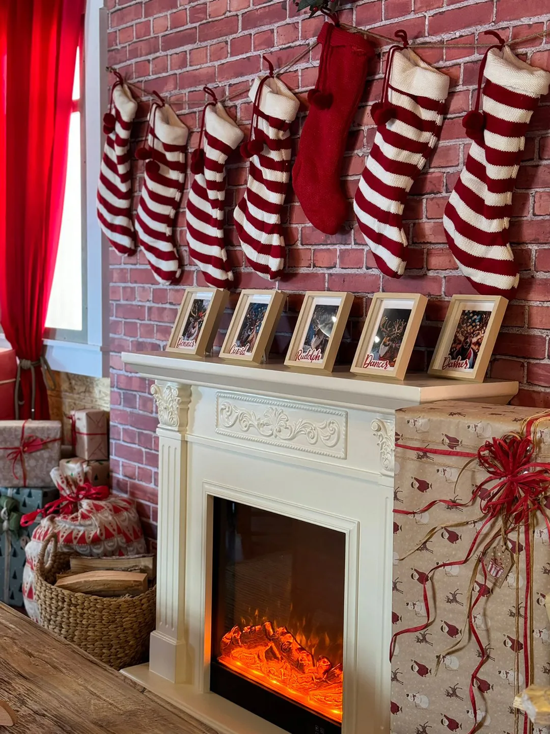 Festive interior joinery with red curtains, shelving, props and painted scenic finishes.