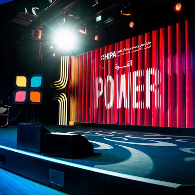 Evolution Scenic broadcast wall illuminated by high-output studio fixtures during a finish assessment.