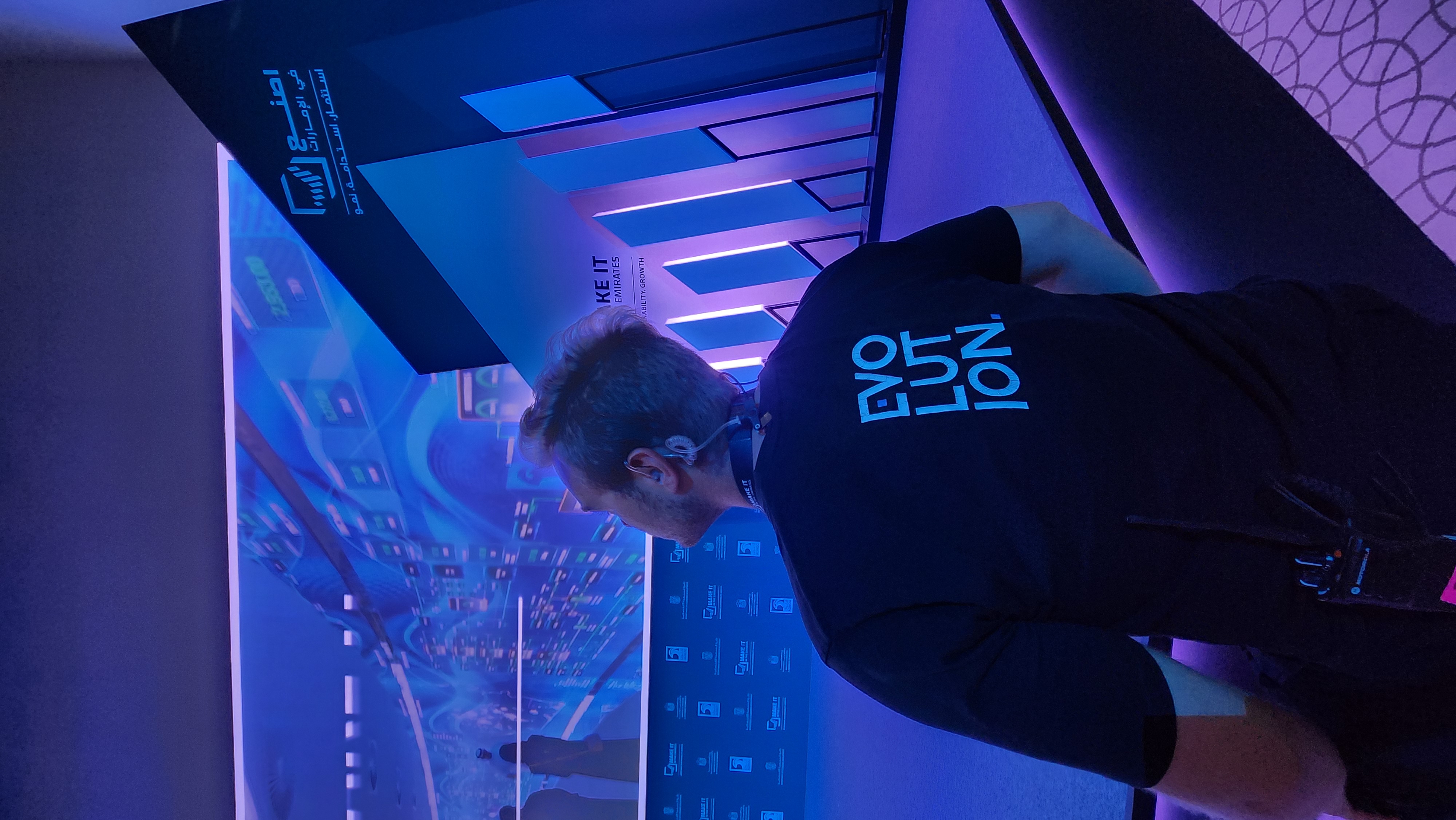 Evolution Scenic technician checking consistent perimeter gaps around an integrated broadcast LED display.