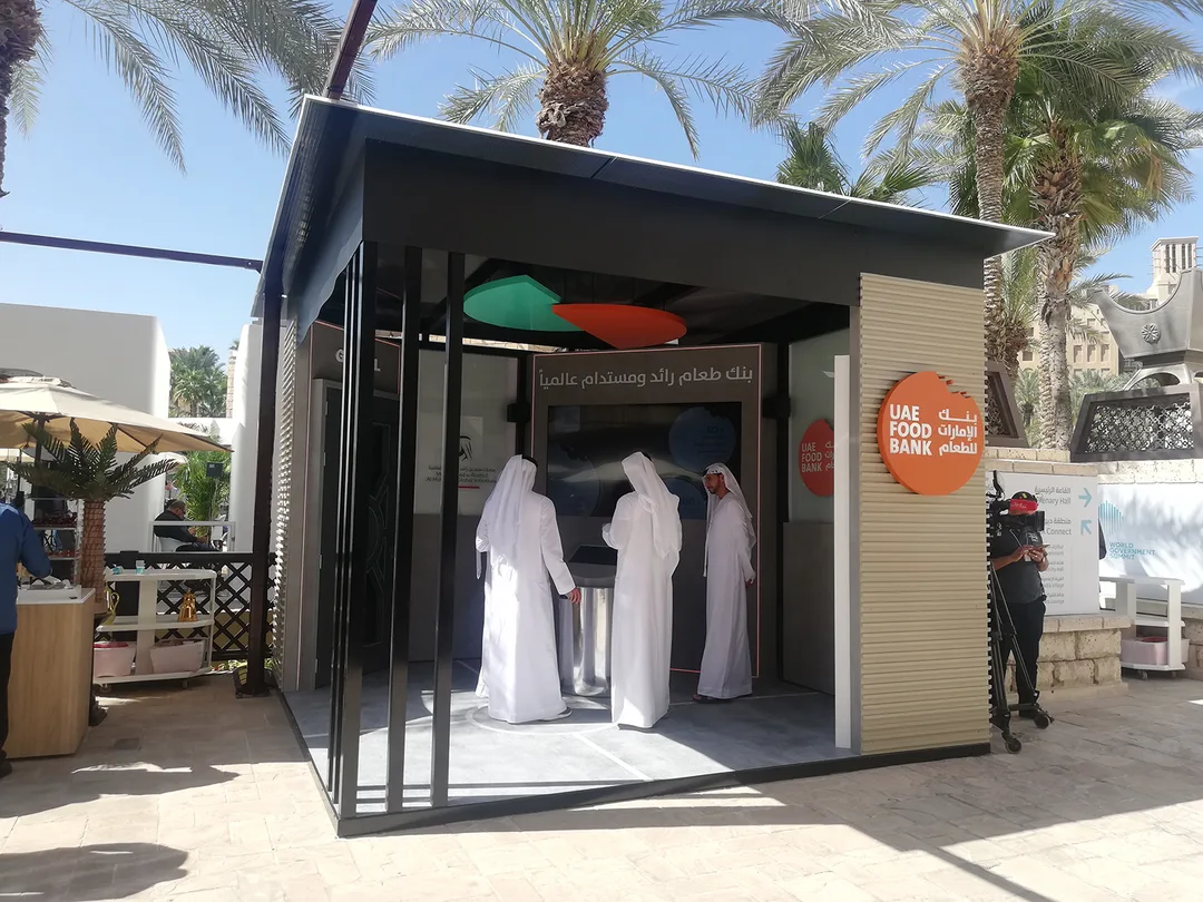 Evolution Scenic fabricated UAE Food Bank stand with sloped roof and illuminated flooring.