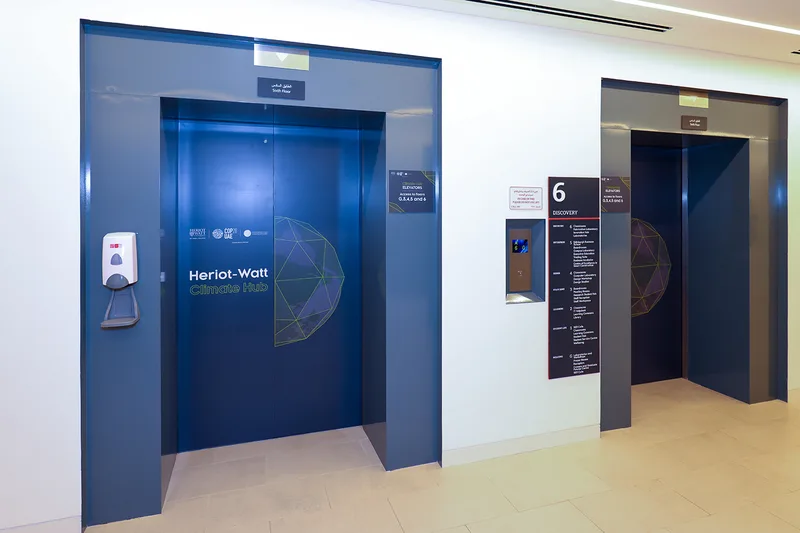 Evolution Scenic elevator and exterior graphics continuing the branding through venue circulation areas.